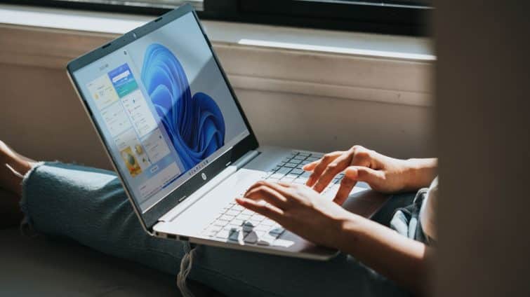 person using Windows 11 computer on lap