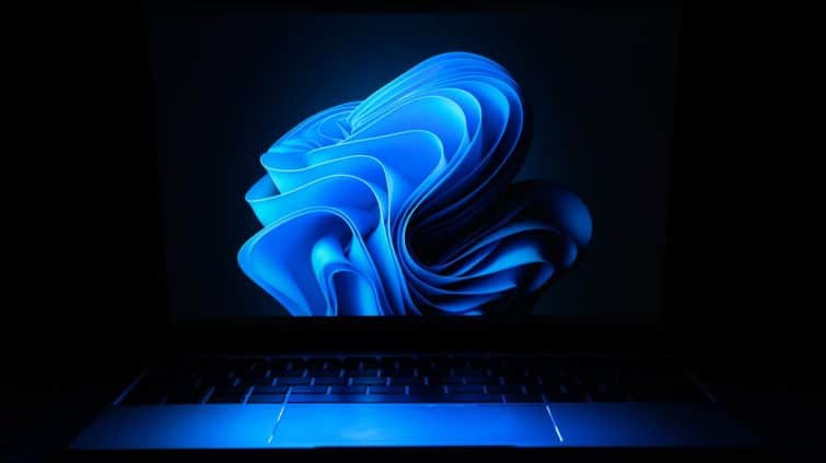 a macbook air laptop in the dark